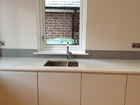 pink glass splashback kitchen